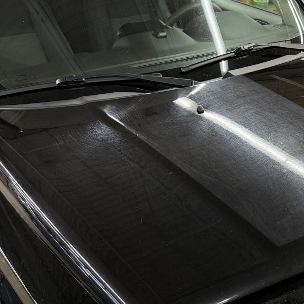 Freshly detailed vehicle hood with a mirror-like finish